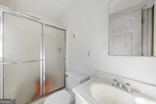 full bathroom with vanity, enclosed tub / shower combo, and toilet