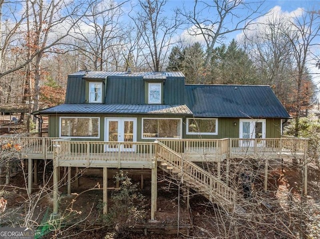 rear view of property featuring french doors and a deck