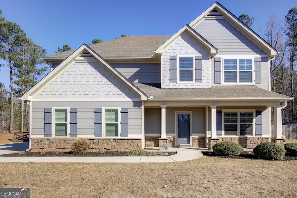 craftsman-style house with covered porch and a front yard