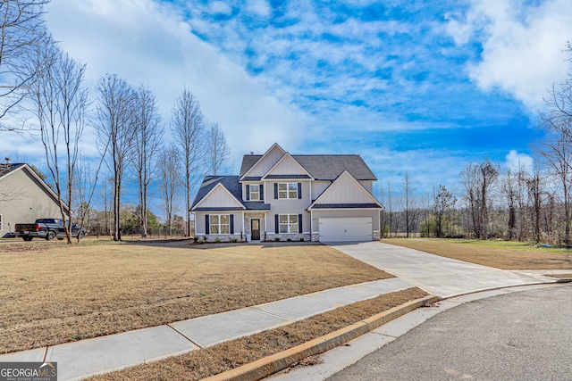 view of front of property with a front yard and a garage