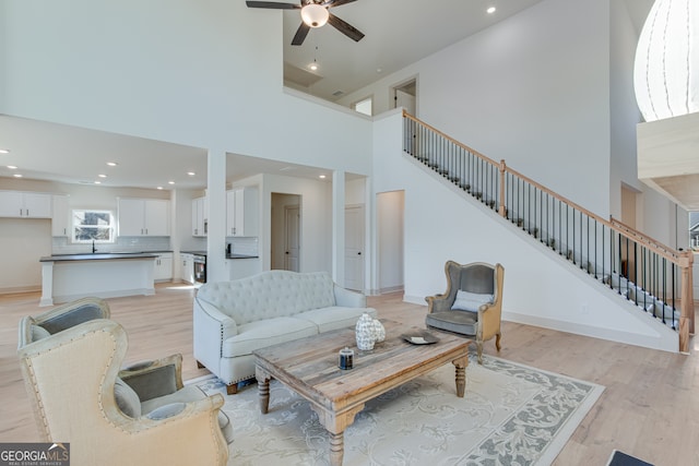 240 Good Hope Preserve, Good Hope, GA 30641 - living area featuring light wood-style flooring, ceiling fan, a high ceiling, recessed lighting, and stairway