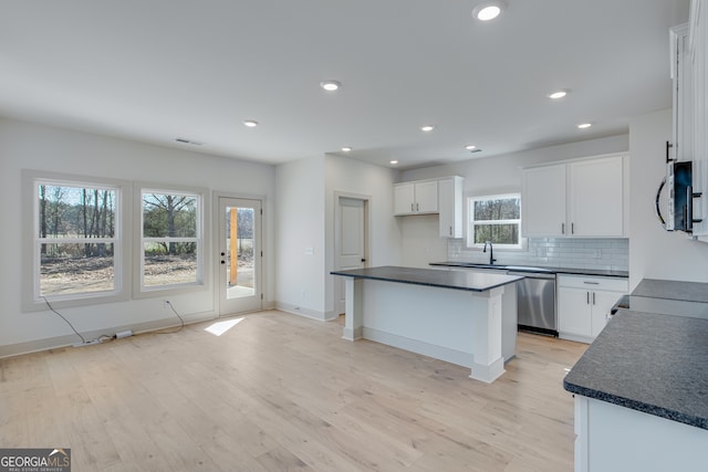 240 Good Hope Preserve, Good Hope, GA 30641 - kitchen with stainless steel appliances, dark countertops, light wood-type flooring, and recessed lighting