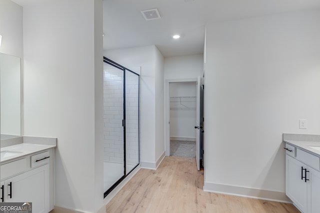 240 Good Hope Preserve, Good Hope, GA 30641 - full bathroom with vanity, a shower stall, a spacious closet, recessed lighting, and wood finished floors