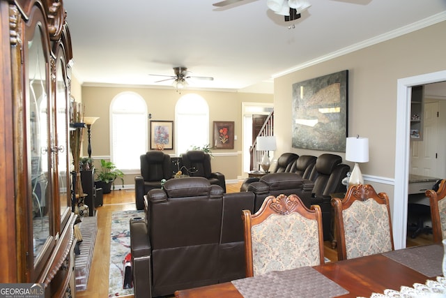 living room with wood-type flooring, ceiling fan, and crown molding