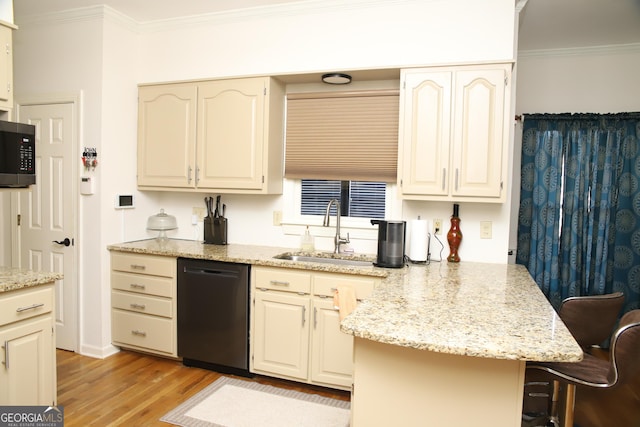 kitchen with light stone countertops, ornamental molding, sink, dishwasher, and a breakfast bar area