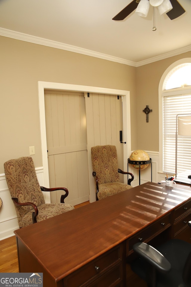 office with hardwood / wood-style floors, ceiling fan, and ornamental molding