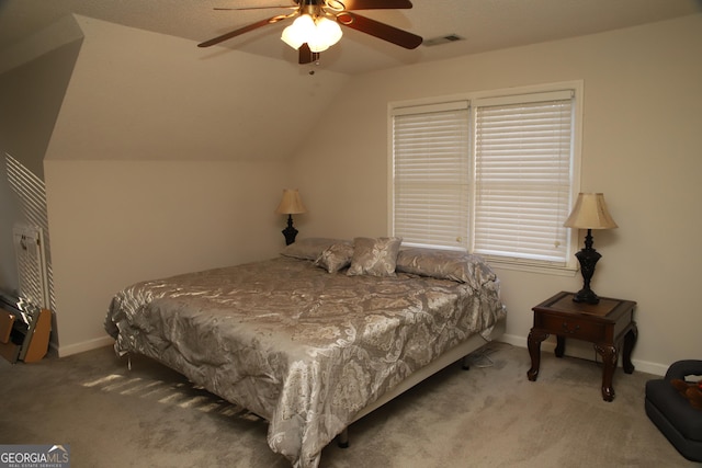 carpeted bedroom with vaulted ceiling and ceiling fan