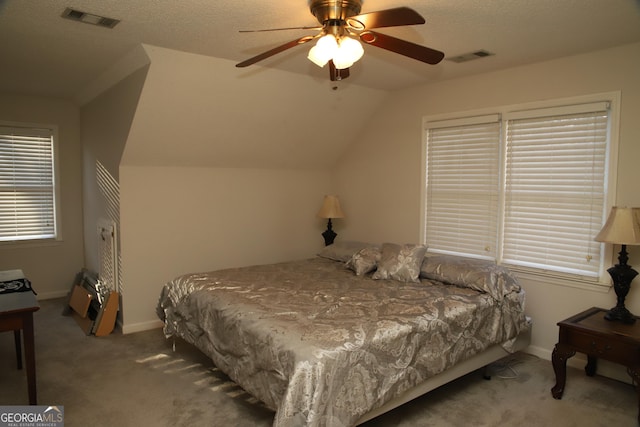 carpeted bedroom with ceiling fan and lofted ceiling