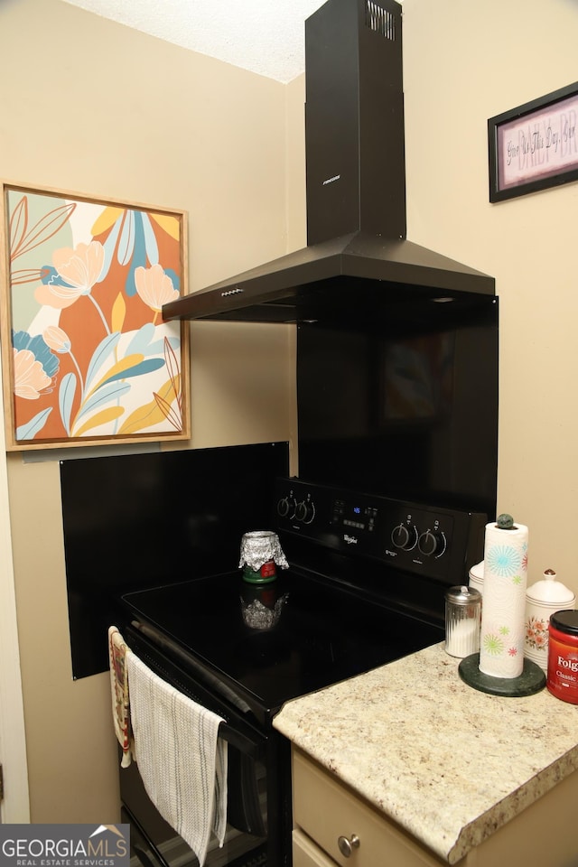 kitchen featuring black / electric stove, light stone countertops, and ventilation hood