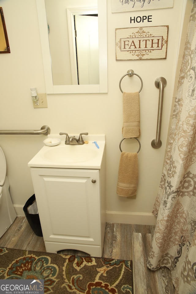 bathroom featuring vanity and hardwood / wood-style flooring