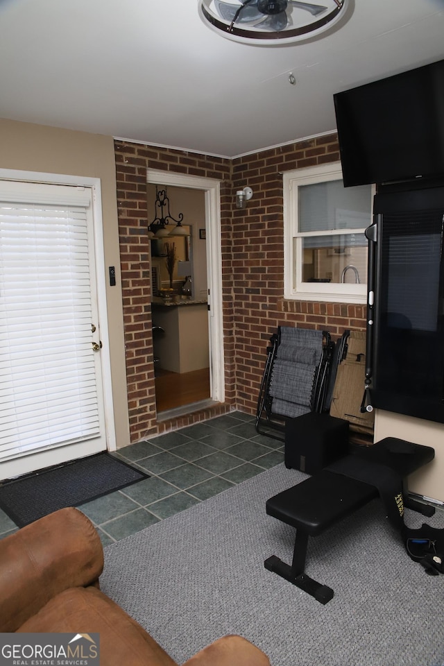 living room featuring brick wall