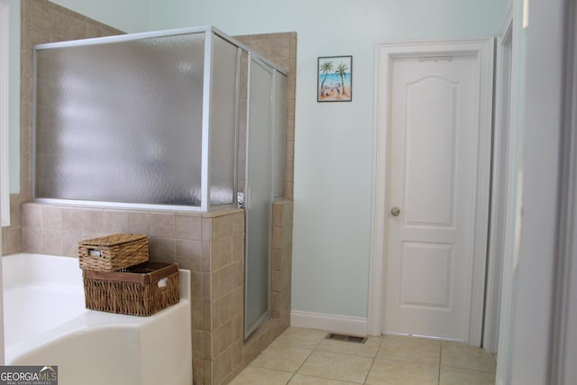 bathroom with tile patterned flooring and walk in shower