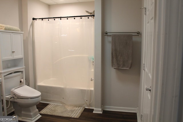 bathroom with hardwood / wood-style floors, toilet, and shower / bathtub combination with curtain