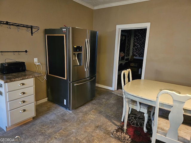 kitchen featuring stainless steel fridge with ice dispenser, white cabinetry, and crown molding