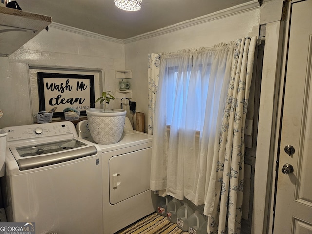 washroom featuring washer and clothes dryer and crown molding