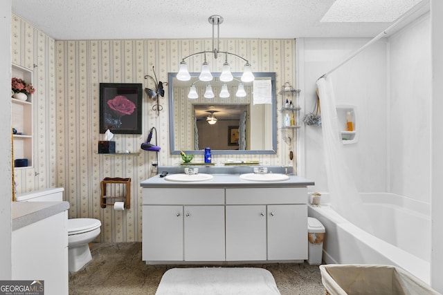 full bathroom featuring vanity, toilet, shower / bath combo with shower curtain, and a textured ceiling