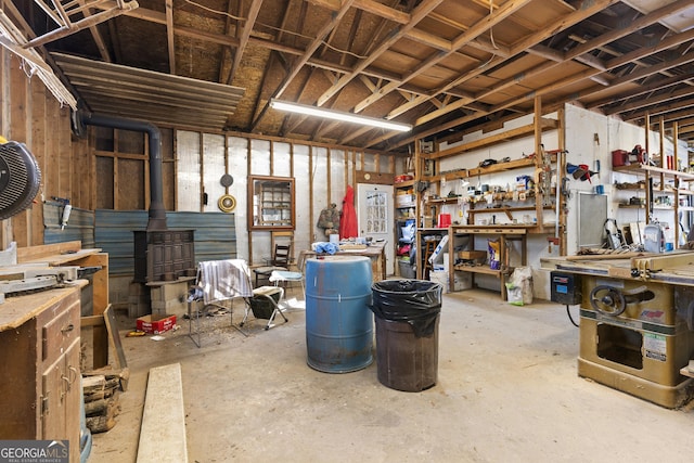 basement featuring a workshop area and a wood stove