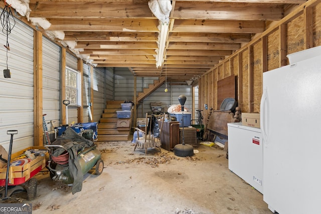 basement featuring white fridge and fridge