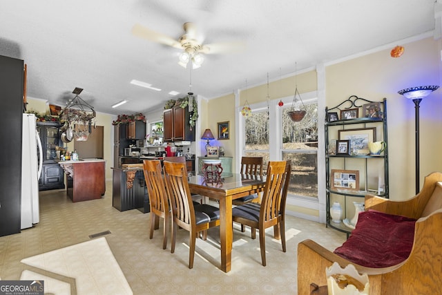 dining area featuring ceiling fan and ornamental molding