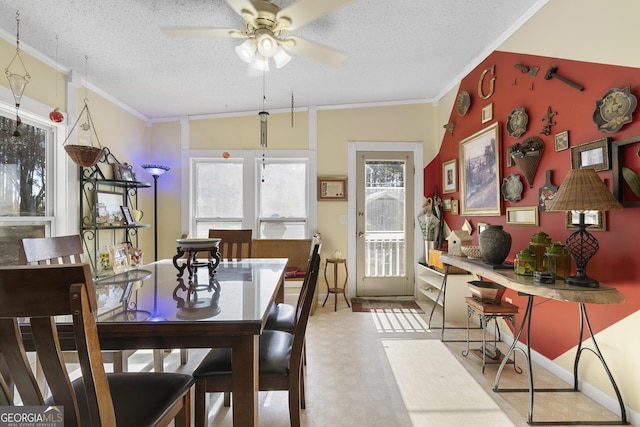 dining room with a textured ceiling, ceiling fan, lofted ceiling, and ornamental molding