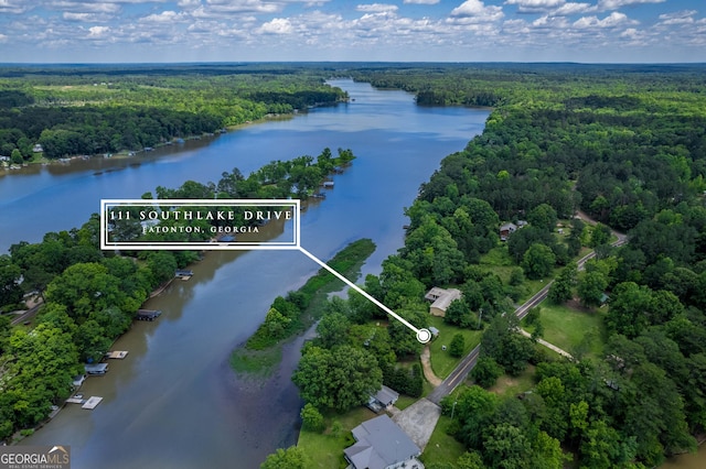 aerial view with a forest view and a water view