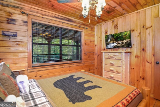 bedroom with wood walls and wooden ceiling