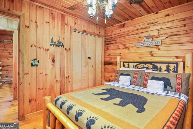 bedroom featuring hardwood / wood-style floors and wood walls