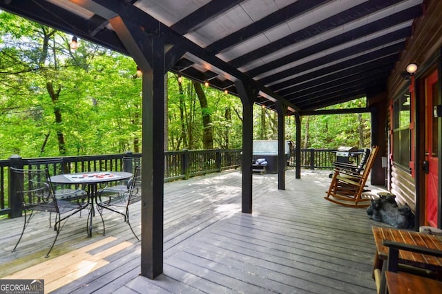 wooden terrace featuring a grill and a hot tub