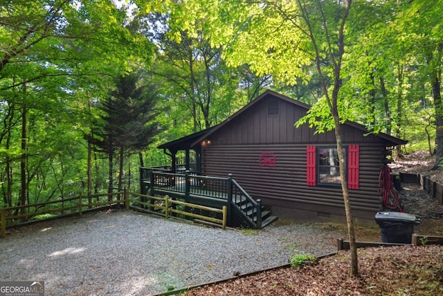 view of side of home with a wooden deck