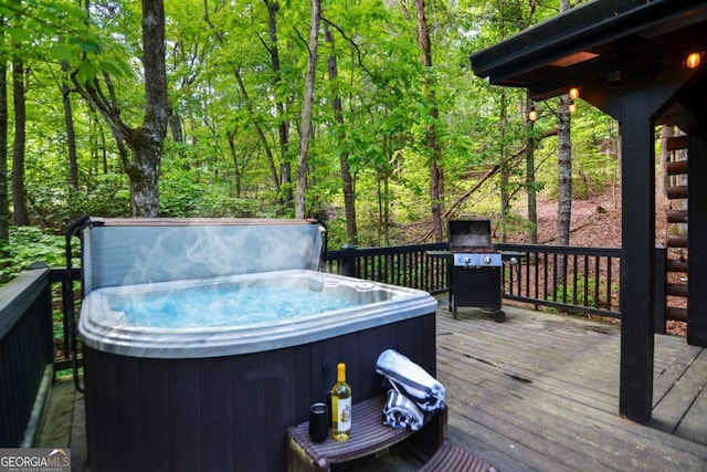 wooden terrace featuring a hot tub