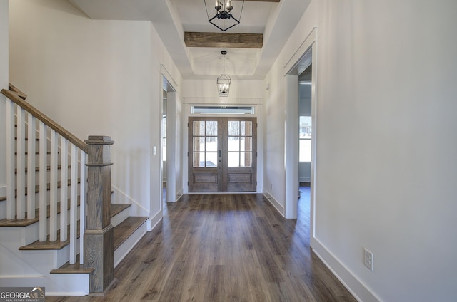 entryway with beam ceiling, french doors, dark hardwood / wood-style floors, and a notable chandelier