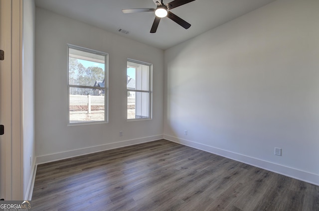 spare room featuring ceiling fan and dark hardwood / wood-style flooring