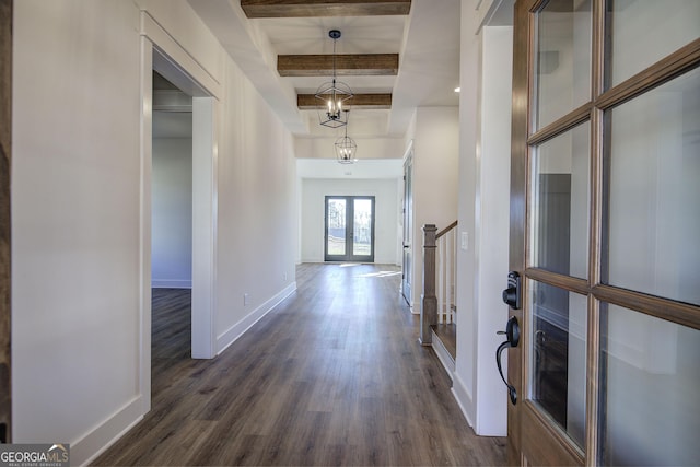 hallway featuring a chandelier, beam ceiling, dark hardwood / wood-style floors, and french doors