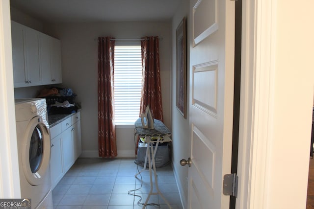 clothes washing area featuring cabinets, washer / dryer, a healthy amount of sunlight, and light tile patterned floors