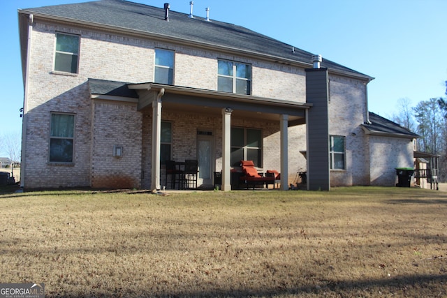 rear view of property featuring a yard