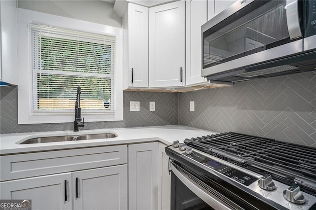 kitchen featuring white cabinetry, sink, and stainless steel appliances