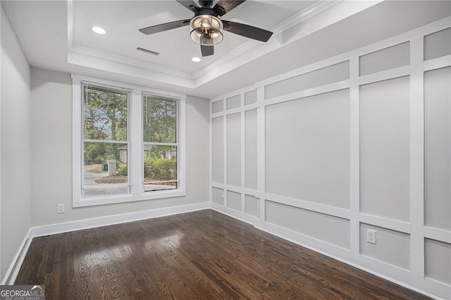 spacious closet featuring dark hardwood / wood-style flooring, a raised ceiling, and ceiling fan