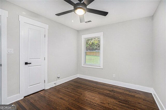 unfurnished bedroom with dark hardwood / wood-style flooring and ceiling fan