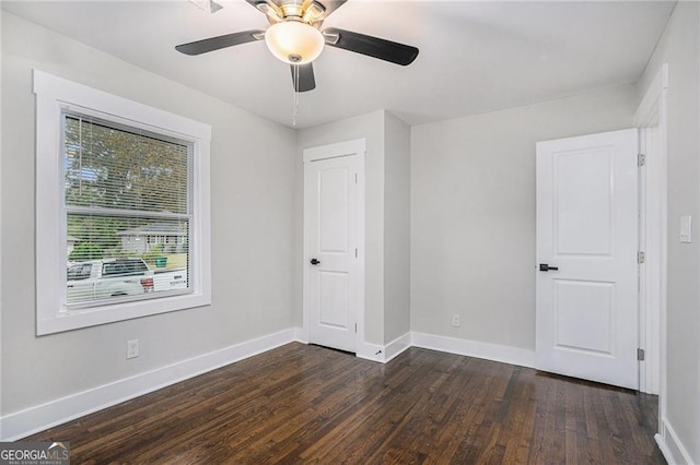 unfurnished bedroom featuring dark wood-type flooring and ceiling fan