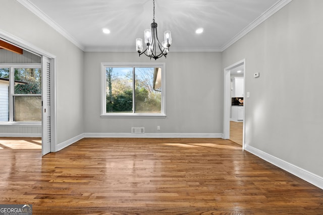 unfurnished dining area with a healthy amount of sunlight, a chandelier, and hardwood / wood-style flooring