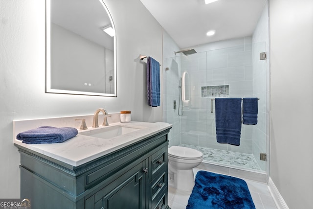 bathroom featuring toilet, vanity, tile patterned floors, and walk in shower