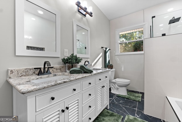 bathroom featuring vanity and toilet