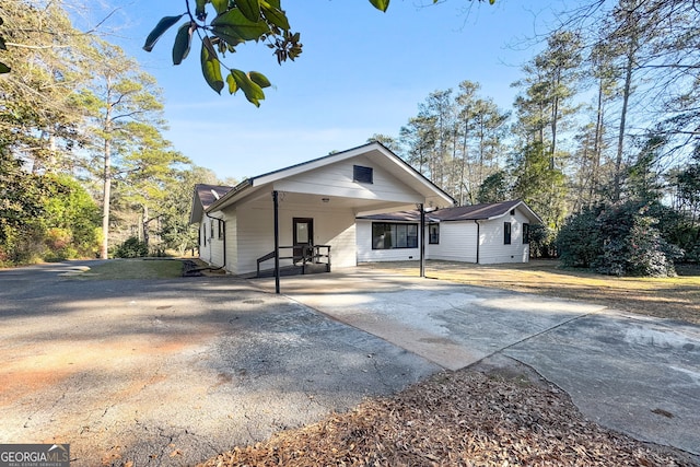 back of house with a carport