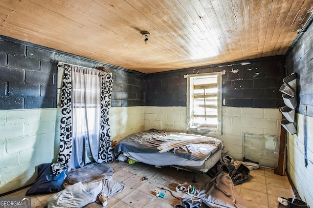 bedroom featuring light tile patterned floors and wood ceiling