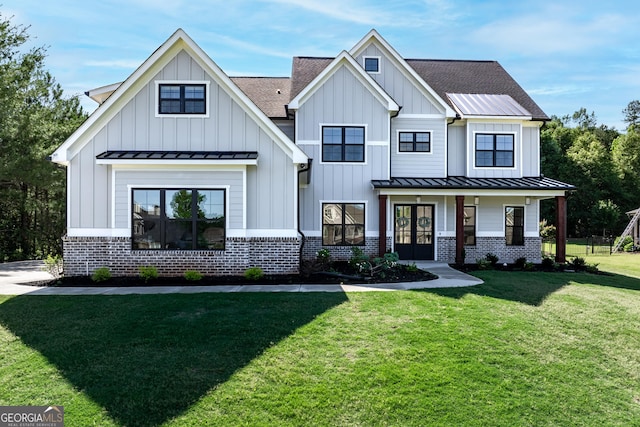 modern inspired farmhouse with a front lawn and covered porch