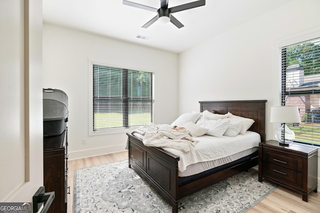 1757 Traditions Way, Jefferson, GA 30549 - bedroom with multiple windows, ceiling fan, and light hardwood / wood-style flooring