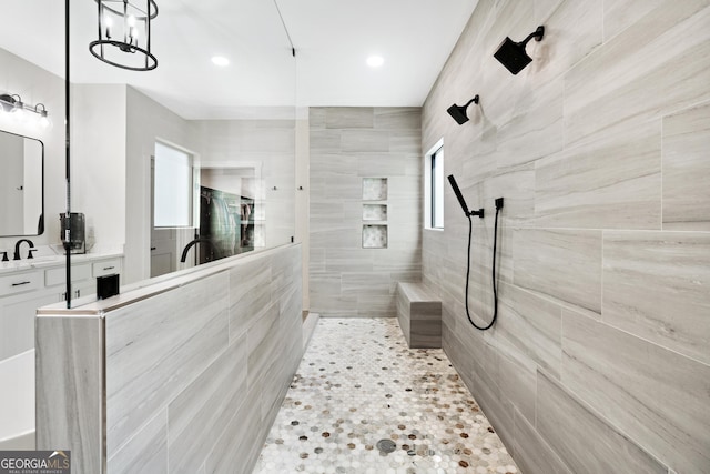 1757 Traditions Way, Jefferson, GA 30549 - bathroom featuring a tile shower, tile patterned floors, vanity, and a chandelier