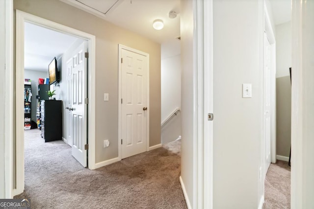 hall featuring light colored carpet