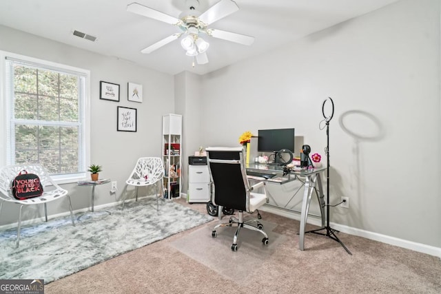 carpeted home office with ceiling fan