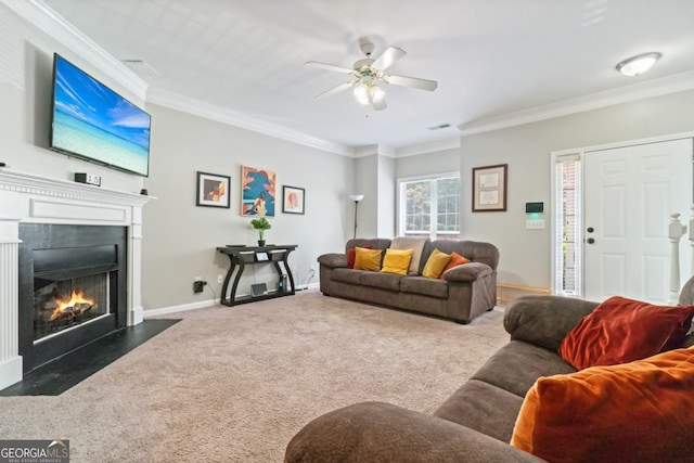 living room featuring ceiling fan, dark carpet, and crown molding